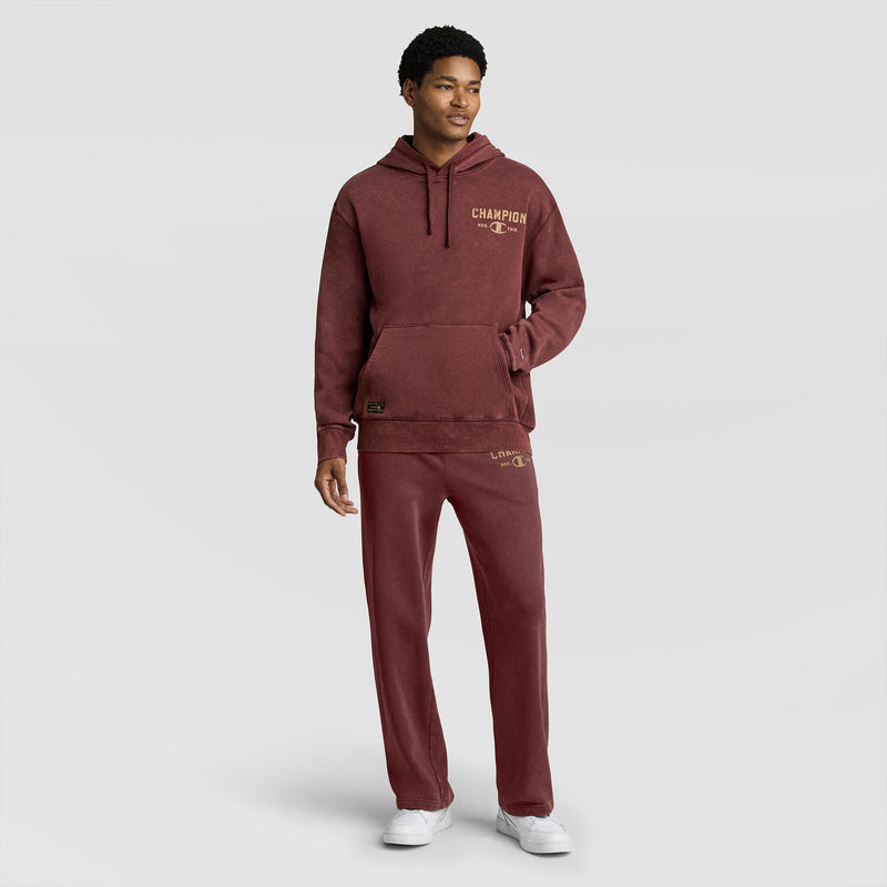 A person wearing a maroon mineral-wash Mineral Wash Pullover Hoodie, C Patch Logo and matching sweatpants.