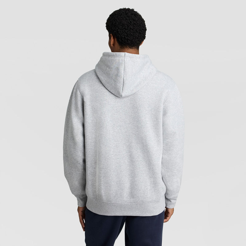 A person seen from behind wearing a light gray Champion Fleece Hoodie, Left Chest Graphic.