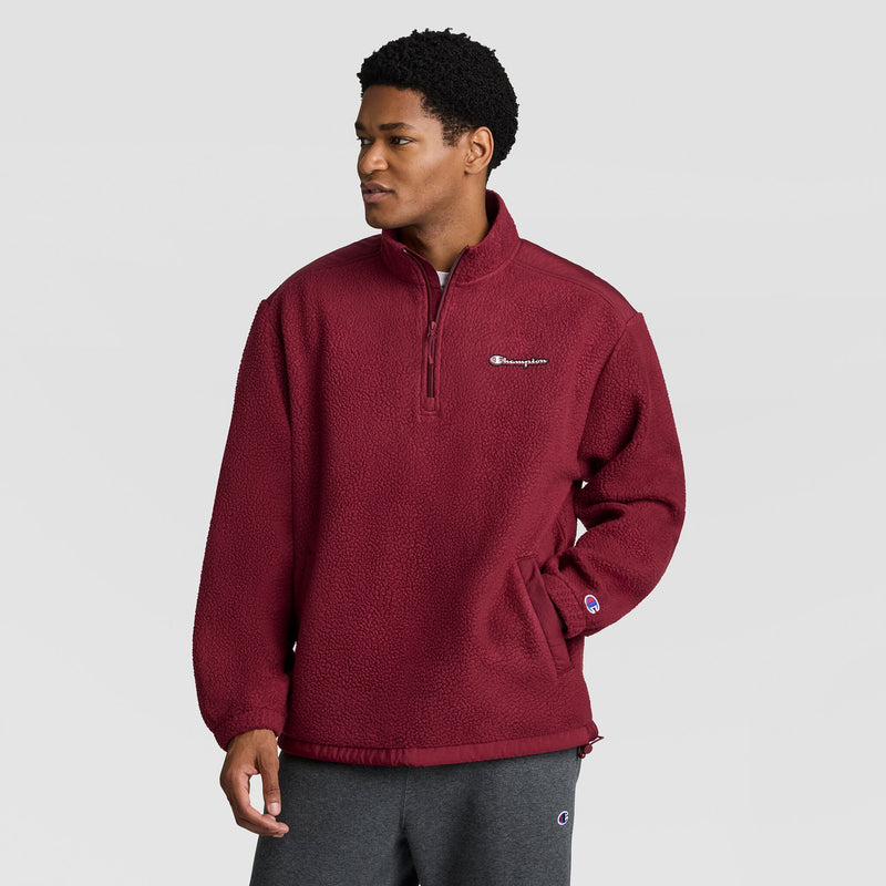 A person wearing a maroon Champion Polar Fleece Quarter Zip pullover with a stand-up collar.