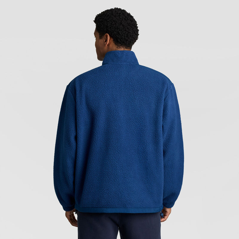 A person seen from the back wearing a blue textured Champion Polar Fleece Quarter Zip.