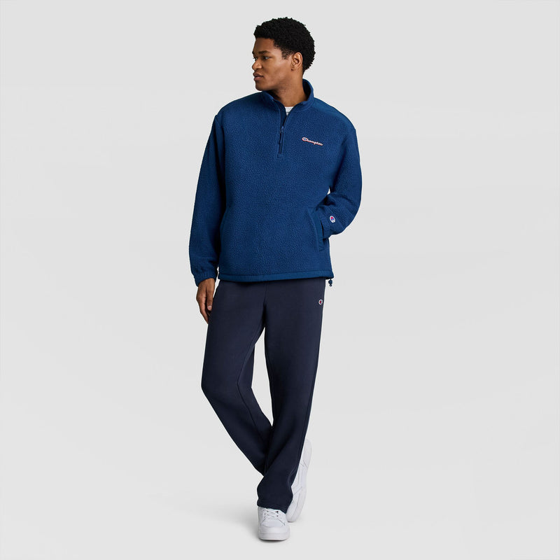 A man wearing a Champion Polar Fleece Quarter Zip and navy sweatpants.