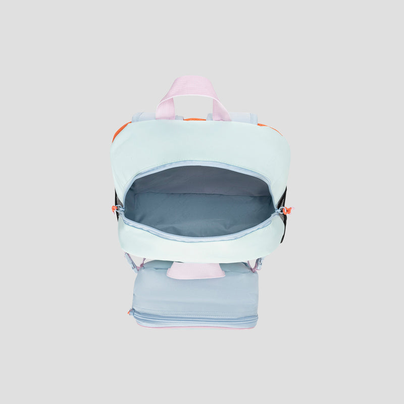 The Champion Kids’ Mode Lunch Kit & Backpack Combo, featuring a light blue and pastel pink design with an open main compartment and a zippered lower section ideal for holding an insulated lunch box, is photographed from above on a simple light gray background.
