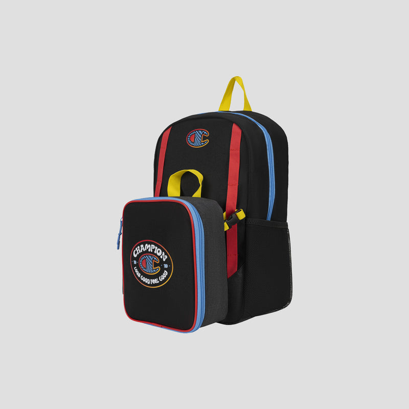 Kids’ Mode Lunch Kit & Backpack Combo by Champion—a black athletic backpack for kids with red, yellow, and blue accents, featuring a Champions patch and a detachable insulated lunch box on the front. Both pieces are designed with colorful zippers and displayed against a plain gray background.