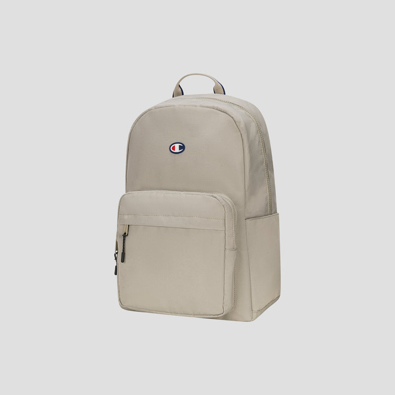 A beige Champion Level Backpack, featuring a front zippered pocket, a small embroidered Champion logo on the upper center, and a padded laptop sleeve for your everyday essentials, displayed against a plain light background.