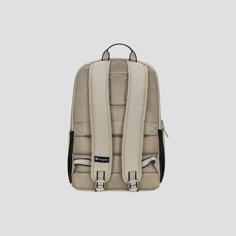 The Champion Level Backpack in beige is displayed from the back against a plain light gray background, showcasing its padded shoulder straps, mesh padding for enhanced comfort, a small Champion logo at the bottom, a handy top handle, and a padded laptop sleeve—making it ideal for everyday use.