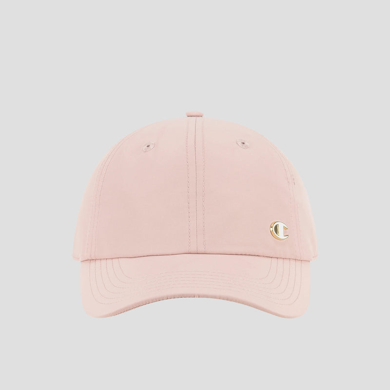A light pink Champion Lifestyle Sport Adjustable Baseball Cap, featuring a small gold C logo on the front left side that highlights the brand’s athletic heritage, is displayed against a plain light gray background.