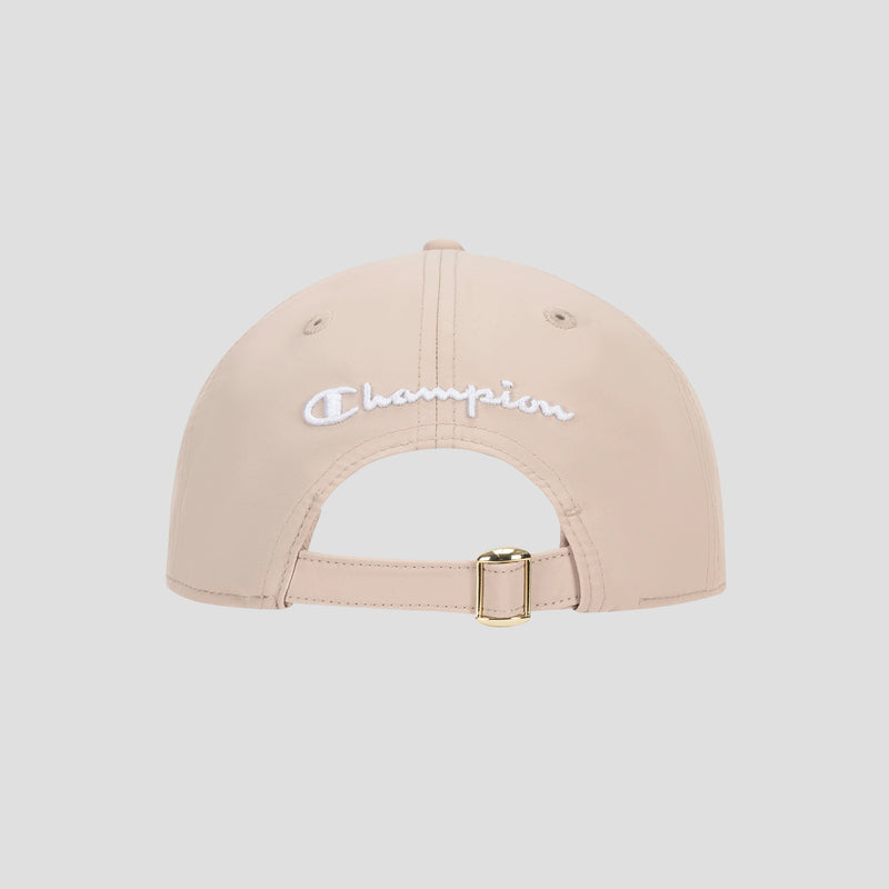 The Champion Lifestyle Sport Adjustable Baseball Cap in beige is shown from the back, highlighting its gold buckle adjustable strap for a customizable fit and featuring white embroidered Champion branding above the opening, reflecting its classic athletic heritage.
