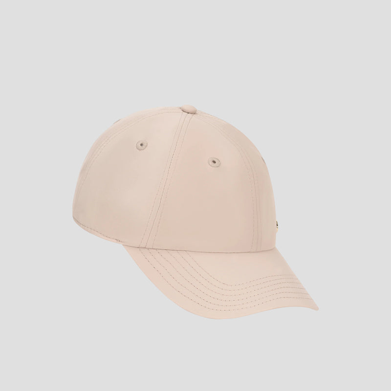 The Champion Lifestyle Sport Adjustable Baseball Cap is featured against a plain, light gray background, highlighting its clean, light beige design with prominent stitching and ventilation eyelets that reflect its athletic roots and customizable fit.