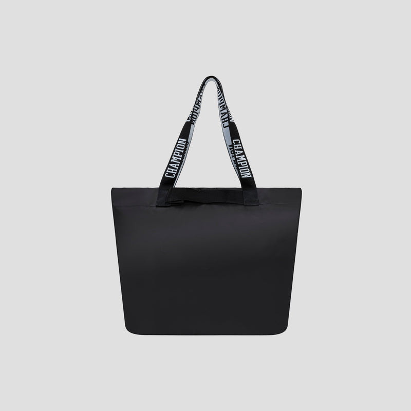 The Miller Coated Shopper Tote by Champion is a spacious black tote bag with two handles, featuring the word “CHAMPION” repeated in white across a black background. Set against a plain light gray backdrop, this stylish bag offers ample room for your essentials while ensuring you stay fashionable on the go.
