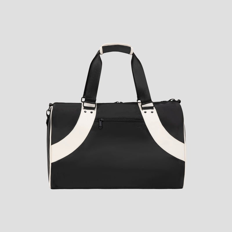 The Champion Oracle Duffel Bag in black, featuring white handles and accents, is displayed against a light gray background. This sports bag includes a zippered front pocket and short carrying straps.