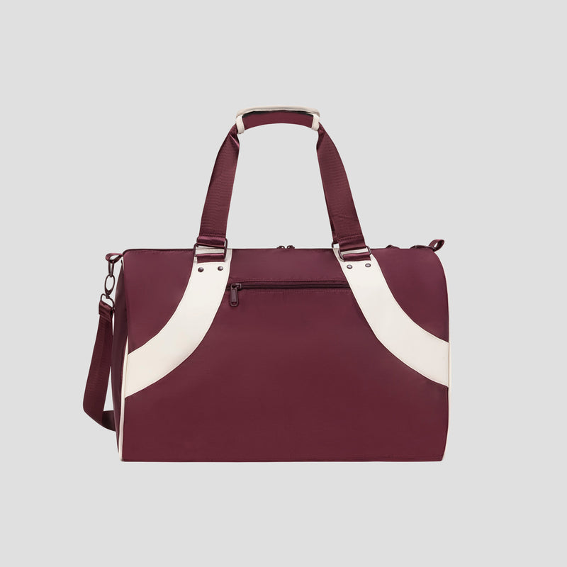 The Champion Oracle Duffel Bag, featuring a maroon design with white curved accents, a top handle, an adjustable shoulder strap, and a front zippered pocket, is displayed against a light gray background.