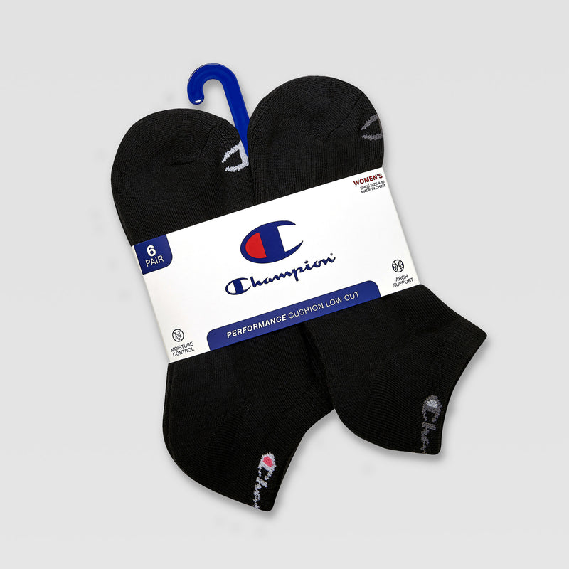 The Champion 6Pk Womens Cushion Low Cut socks offer cushioned support and moisture-wicking comfort. The black socks come in a 6-pair pack with a white and blue Champion label and are attached with a blue plastic hanger.