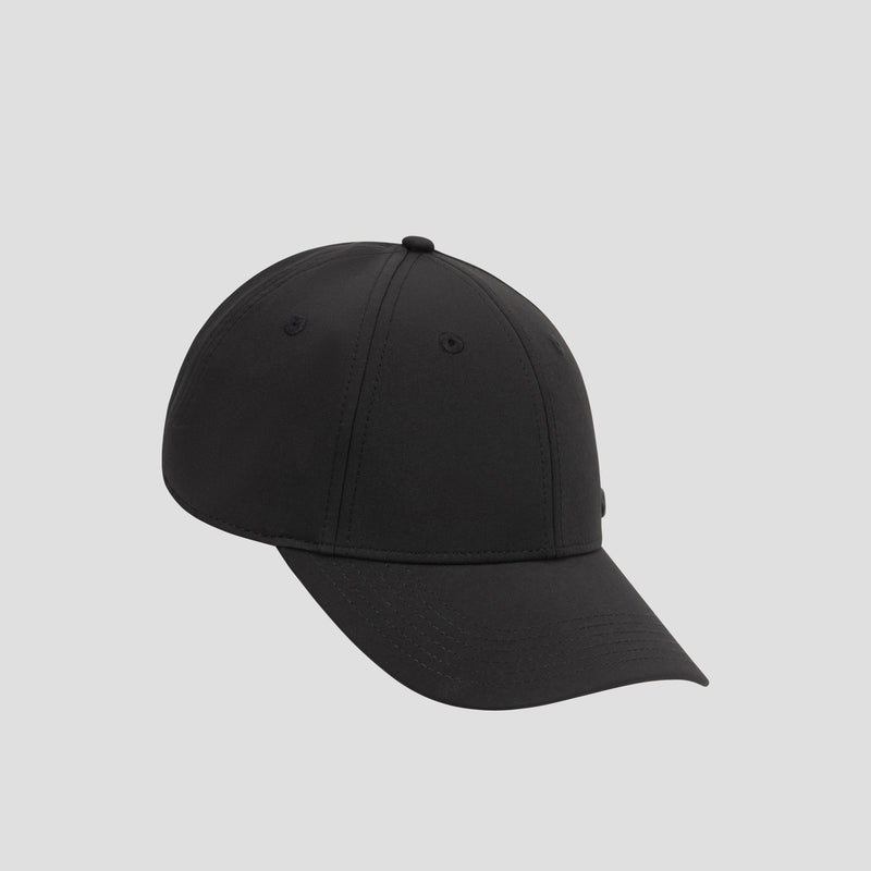 A Champion Ponytail Baseball Cap, crafted from performance stretch fabric in plain black, is displayed on a light gray background and angled slightly to the left.