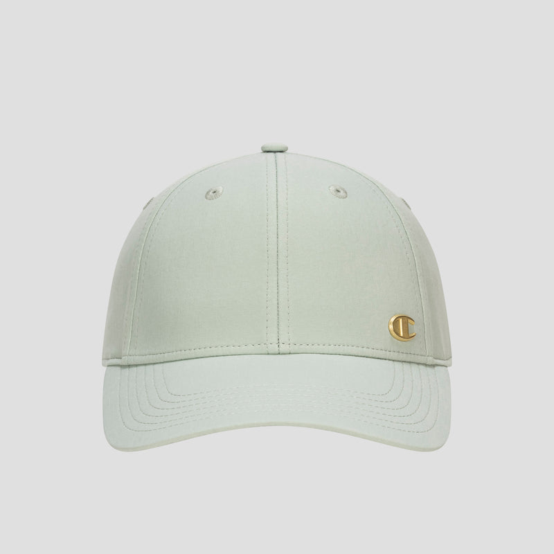 The Champion Ponytail Baseball Cap, crafted from performance stretch fabric in light green, features stitching detail, eyelets on top, and a small gold C emblem on the front left panel. It is showcased against a plain white background.