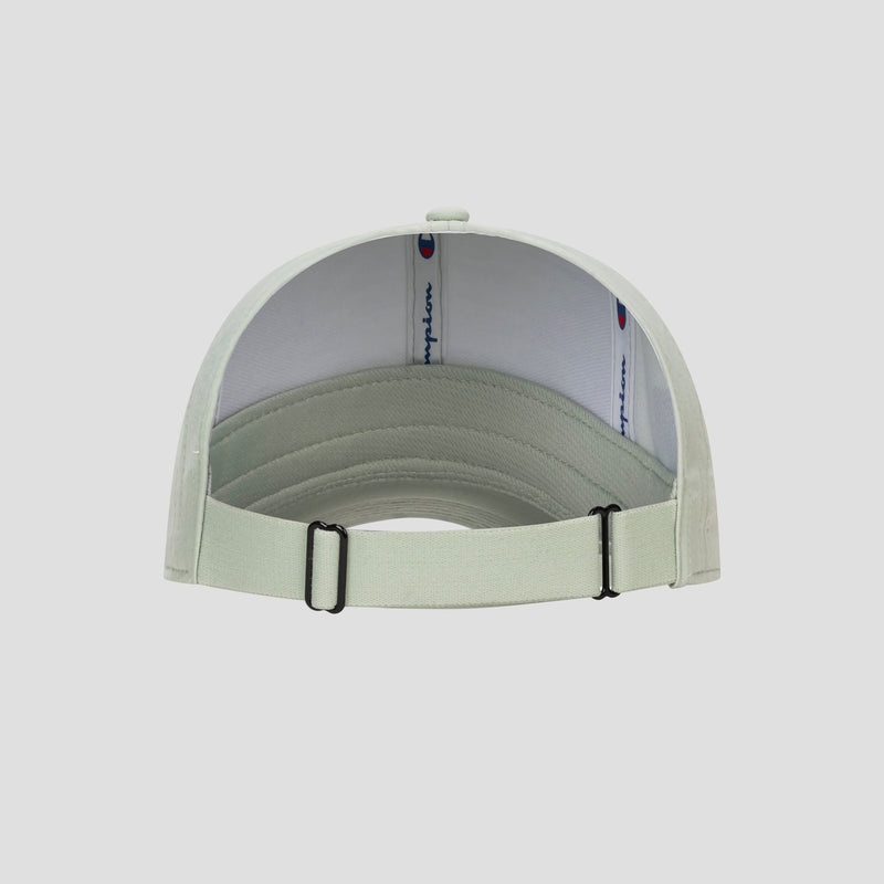 A light gray Champion Ponytail Baseball Cap is viewed from the back, featuring an adjustable strap with a metal buckle. Made from performance stretch fabric, the inner band displays the Champion logo on a white background. The cap is set against a plain, light backdrop.