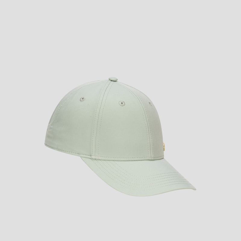 The Champion Ponytail Baseball Cap, shown against a plain light background, is crafted from performance stretch fabric in light green and features a curved brim, six-panel construction, and stitched eyelets.