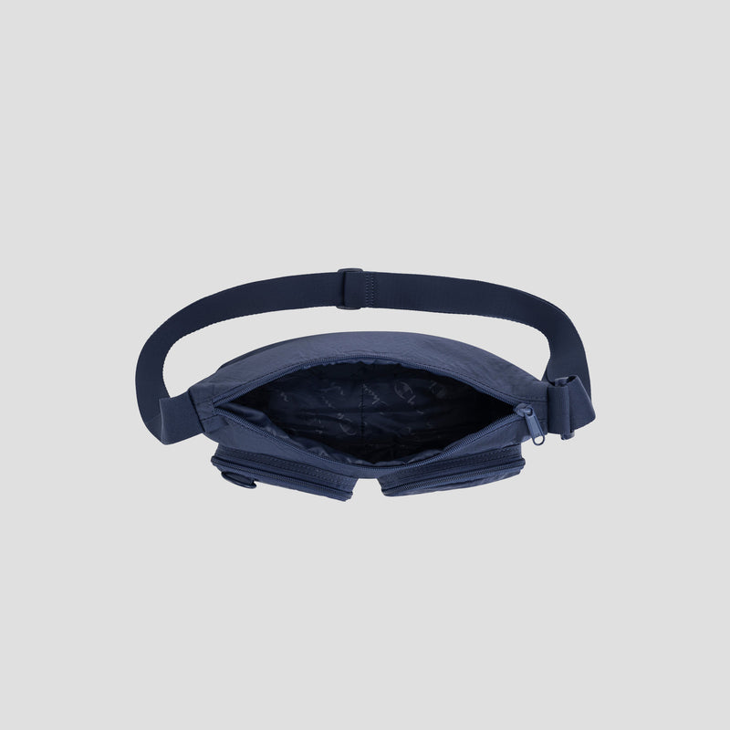 The Champion Quartz Small Messenger Bag in navy blue, featuring an adjustable strap and shown unzipped to reveal its empty interior, is displayed against a light grey background.