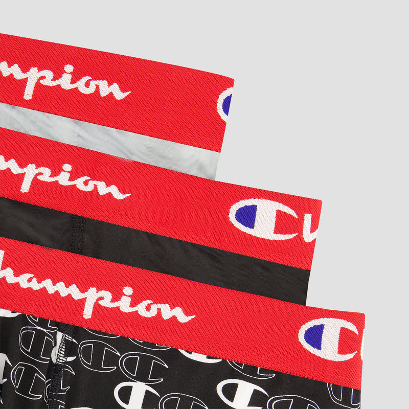 A 3Pk Performance Boxer Brief set by Champion, showing three pairs stacked with red waistbands, white Champion logos, and black briefs featuring a white C pattern on the bottom pair.