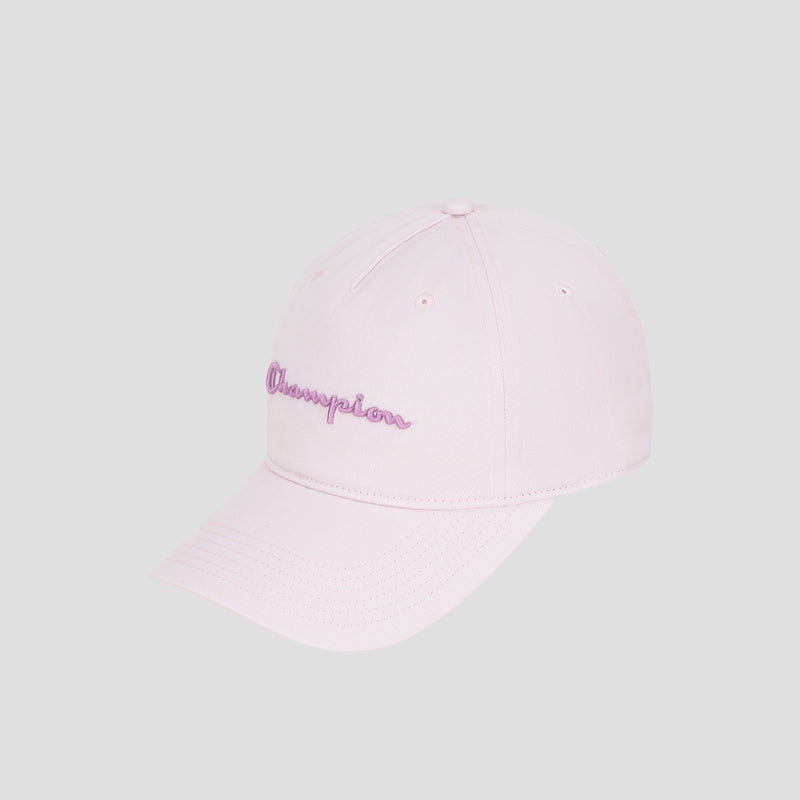 The Script Embroidery Adjustable Cap by Champion is crafted from premium cotton twill in a light pink hue, featuring the word “Champion” embroidered in purple cursive on the front. The cap is displayed against a plain light gray background.