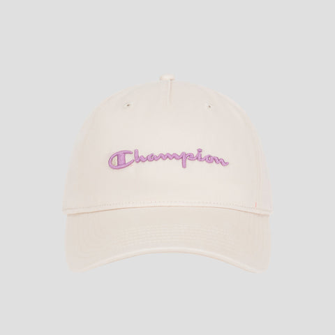 The Champion Script Embroidery Adjustable Cap is made from premium washed beige cotton twill and showcases “Champion” embroidered in purple cursive on the front, set against a simple light gray background.