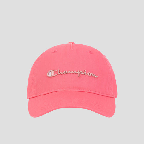 The Champion Script Embroidery Adjustable Cap is crafted from vibrant pink washed cotton twill and showcases beige Champion script embroidery on the front. This cap features an adjustable strap and is photographed against a light gray background.