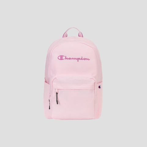 A light pink Steady Backpack by Champion featuring a front pocket, zipper closures, a padded laptop sleeve, and the Champion logo embroidered in pink and purple on the front.
