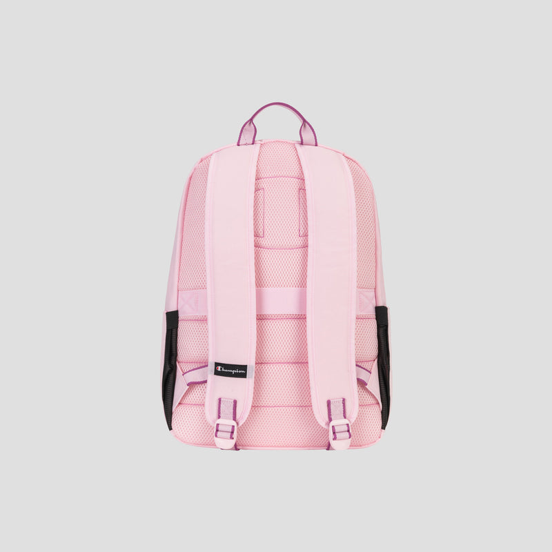 The Champion Steady Backpack in light pink features padded shoulder straps, a padded laptop sleeve, mesh side pockets, a top carrying handle, and a small black tag, displayed against a plain gray background.