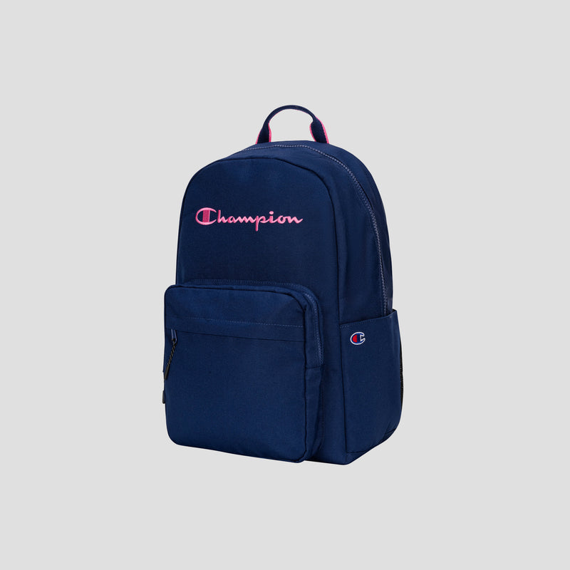 The Champion Steady Backpack in navy features a front pocket and is adorned with a pink embroidered Champion logo on the front, making it ideal for use as a laptop backpack. The product is photographed against a plain gray background.