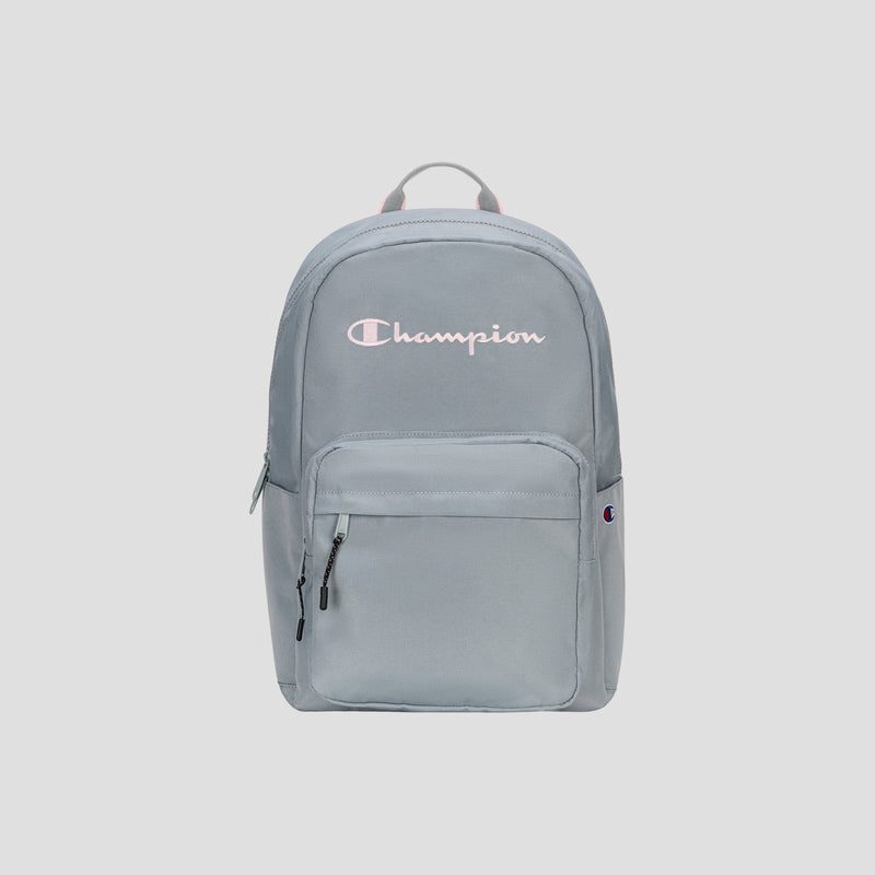 Introducing the Steady Backpack from Champion: this light gray bag features a front zip pocket, dual zipper pulls, and the Champion logo in white and pink displayed across the upper front. Designed with a fabric top handle and a streamlined, minimalist look, it’s perfect for carrying all your essentials in style.