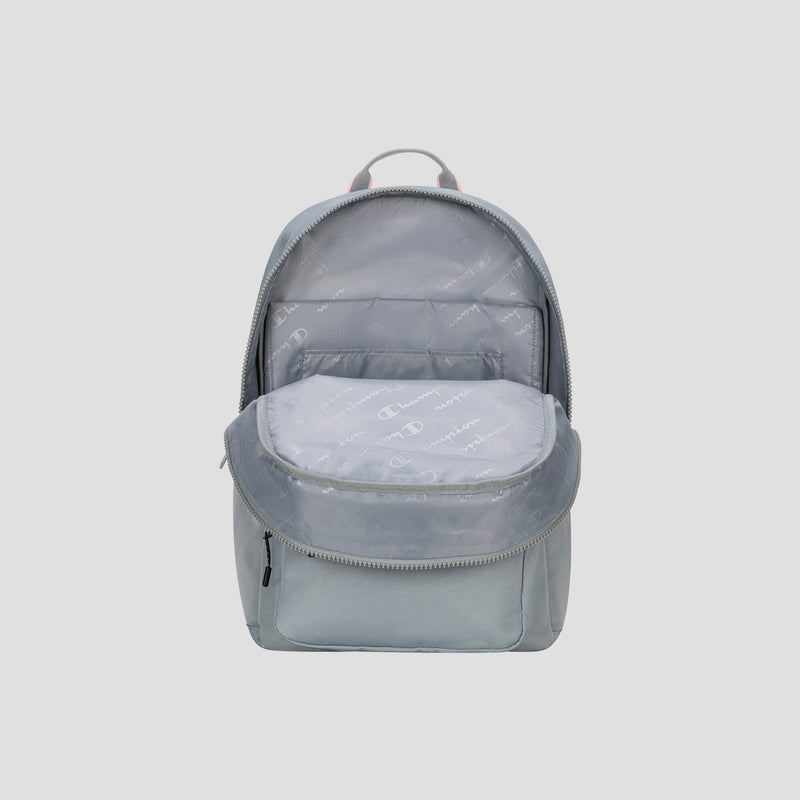 A light gray Champion Steady Backpack with the main compartment unzipped, revealing a spacious interior lined with fabric patterned in small, repeating C logos. The front pocket remains closed.