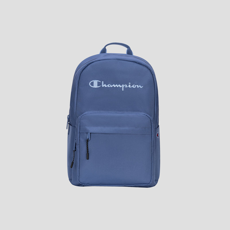 The Champion Steady Backpack in blue features a top handle, front zippered pocket, and displays the Champion logo in white on the upper front. Designed to accommodate your daily essentials, it offers secure storage for up to a 17″ laptop.
