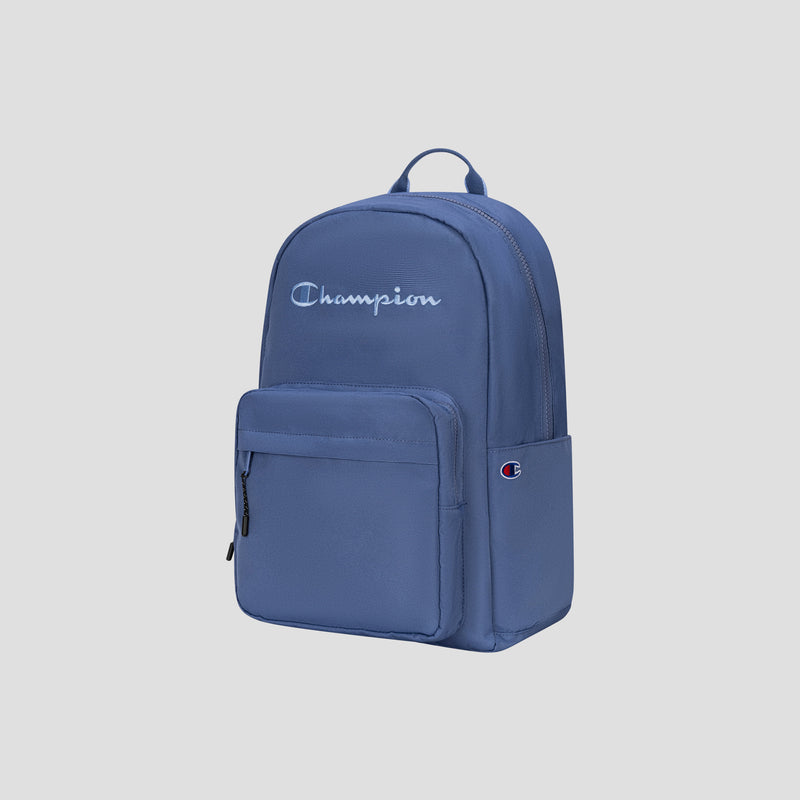 Here’s a rewritten sentence using the provided product data: The Champion Steady Backpack in blue features a front zip pocket, a top handle, and a white Champion logo on the upper front. Designed for everyday use, it also includes the small Champion C logo patch on the right side pocket and accommodates laptops up to 17 inches.