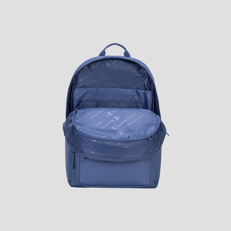 A blue Champion Steady Backpack with its main compartment unzipped, revealing a spacious interior ideal for a 17″ laptop and a small front zip pocket, displayed against a plain light gray background.
