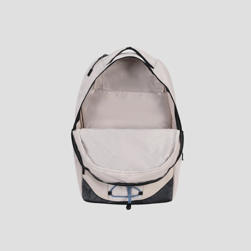 The Champion Summit Backpack is shown in beige with its main compartment open, revealing a roomy interior that includes a padded laptop sleeve and a convenient front pocket. Featuring black trim and an eye-catching blue and white drawstring detail at the bottom, this backpack blends style with weather-resistant materials for reliable everyday use.