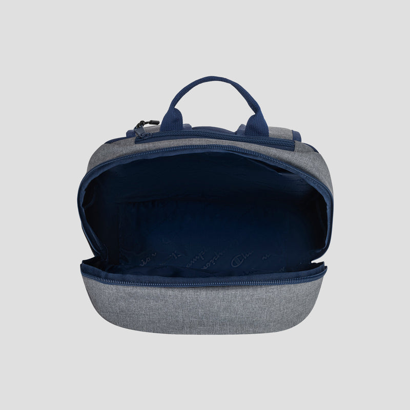 The Champion System Backpack in gray and navy blue features a spacious main compartment with a padded laptop sleeve for enhanced protection. It includes dual top handles, multiple storage compartments, and a zippered front pocket.