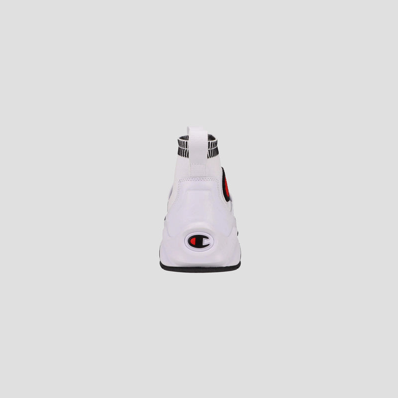 The Champion Kids' Rally Pro is a white athletic knit sneaker with a black, white, and red Champion logo on the heel and a striped pull tab at the back, shown from the rear on a plain light gray background.