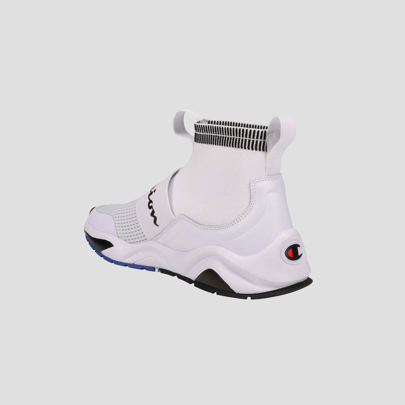 The Champion Kids' Rally Pro features a white knit slip-on design with a high sock-like collar, black and blue sole accents, and the Champion logo on the heel—shown from the back against a plain light background.