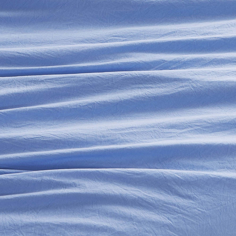 Soft light blue fabric featuring gentle, wavy folds and subtle horizontal creases, creating a textured appearance reminiscent of the Champion Elastic Logo Microfiber Sheet Set by Champion.