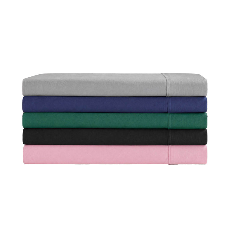 A neatly arranged stack of five Champion Peak Comfort Microfiber Sheet Sets in gray, navy blue, green, black, and pink is displayed on a white background—each set features deep pocket sheets for a snug fit, designed as athletic bedding to provide ultimate comfort.