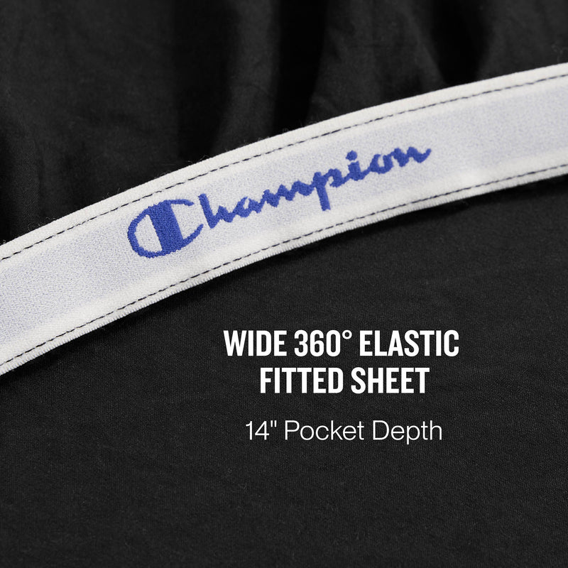 A close-up of a black fitted sheet with a white elastic band labeled Champion. Text reads: Peak Comfort Microfiber Sheet Set by Champion—wide 360° elastic fitted sheet with 14″ pocket depth, designed for deep mattresses and perfect for athletic bedding.