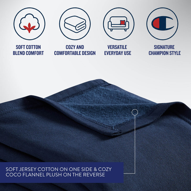Detailed view of the navy blue fabric reveals soft jersey cotton on one side and plush fleece backing on the reverse. Icons above highlight comfort, coziness, versatile use, and signature Champion style—making this Champion Jersey with Fleece Backing Throw Blanket an essential piece for athletic bedding or a go-to fleece blanket for everyday relaxation.