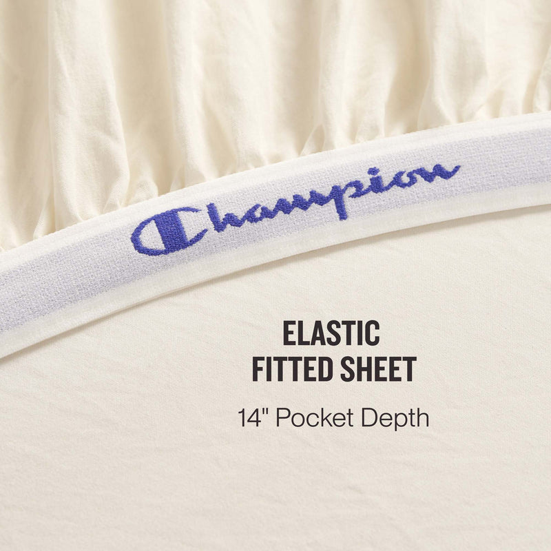 Close-up of the Champion Elastic Logo Microfiber Sheet Set’s cream-colored fitted sheet, featuring a branded elastic band and a 14-inch pocket depth for daily comfort. Text reads: ELASTIC FITTED SHEET 14″ Pocket Depth.