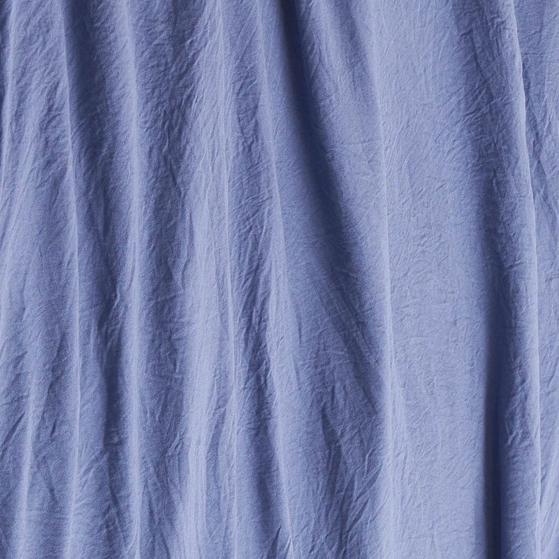Blue wrinkled fabric with visible vertical creases and folds, creating a textured appearance reminiscent of the Champion Embroidery Patch Microfiber Sheet Set.
