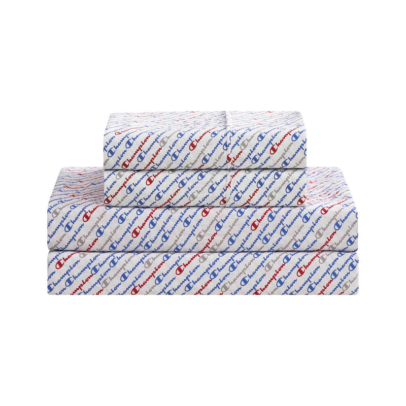 Three neatly stacked Champion Printed Microfiber Sheet Sets, featuring an all-over repeating Champion logo in red and blue on a white background. These super-soft sets are arranged from largest on the bottom to smallest on top, displayed against a clean white backdrop.