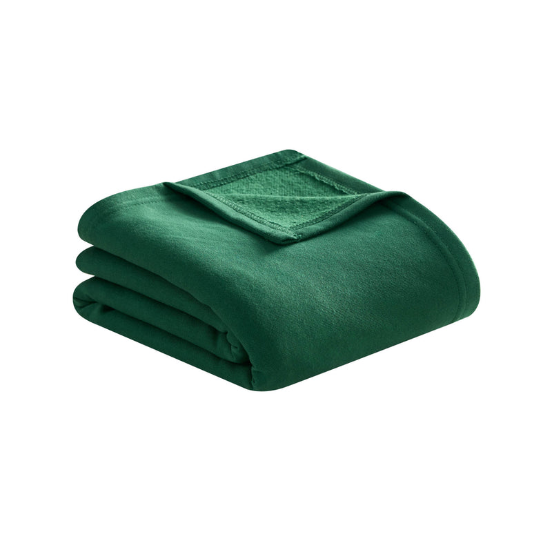 A neatly folded green Jersey with Fleece Backing Throw Blanket by Champion, featuring a visible stitched edge, displayed on a white background.