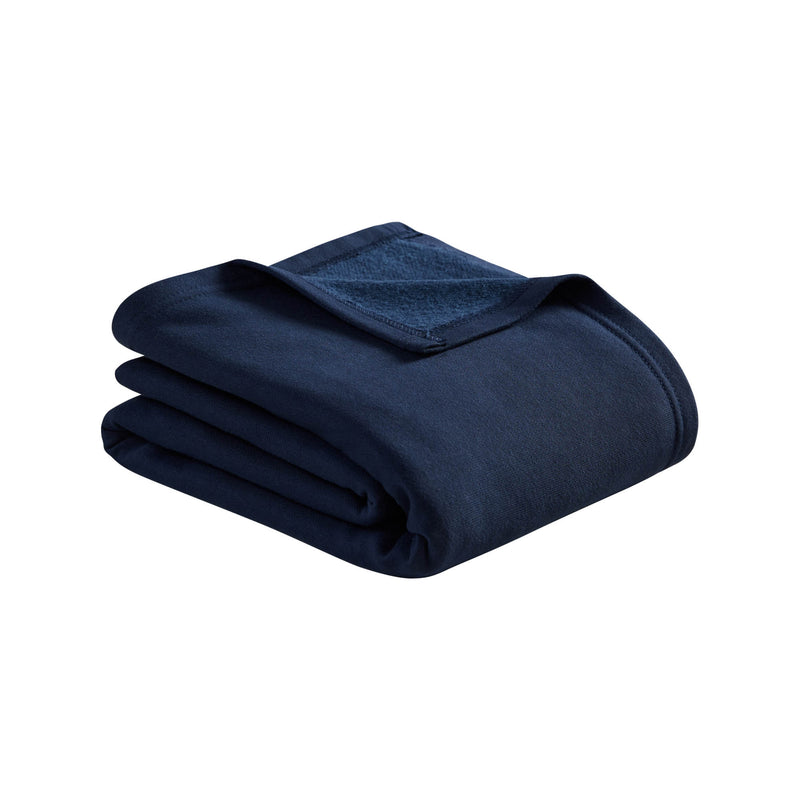 A neatly folded Champion Jersey with Fleece Backing Throw Blanket in dark blue, with a small corner flipped over, displayed on a white background.