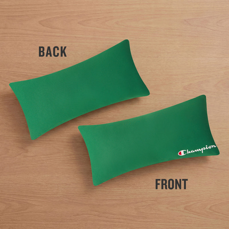 Two green rectangular Champion Jersey Body Pillows rest on a wooden surface—one displays the plain green back, while the other reveals the iconic white and red Champion logo on the front. These sporty body pillows add an athletic accent to any space, reminiscent of the comfort found in your favorite jersey knit.