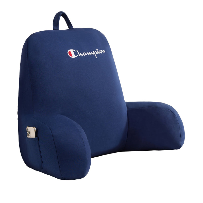 The Champion Jersey Backrest Pillow features a navy blue jersey knit fabric, supportive armrests, a convenient small side pocket for your phone, and the iconic Champion logo embroidered on the top.