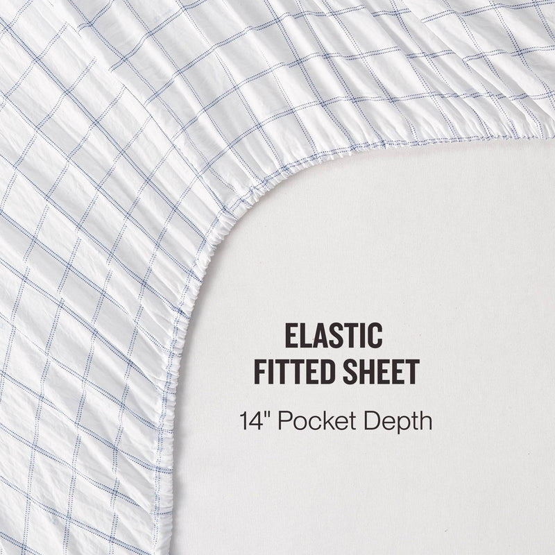 Champion Printed Microfiber Sheet Set with a blue grid pattern is shown partially covering a mattress; text reads: Elastic Fitted Sheet, 14″ Pocket Depth. Enjoy the convenience of wrinkle-resistant sheets from Champion that stay smooth and neat for effortless style and comfort.
