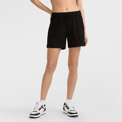 Person wearing black shorts on a white background